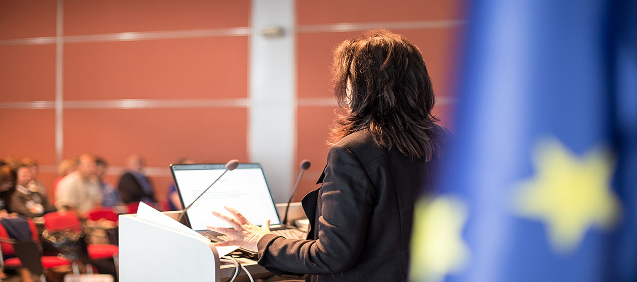 This is a stock photo. A woman speaking at a United Nations event.